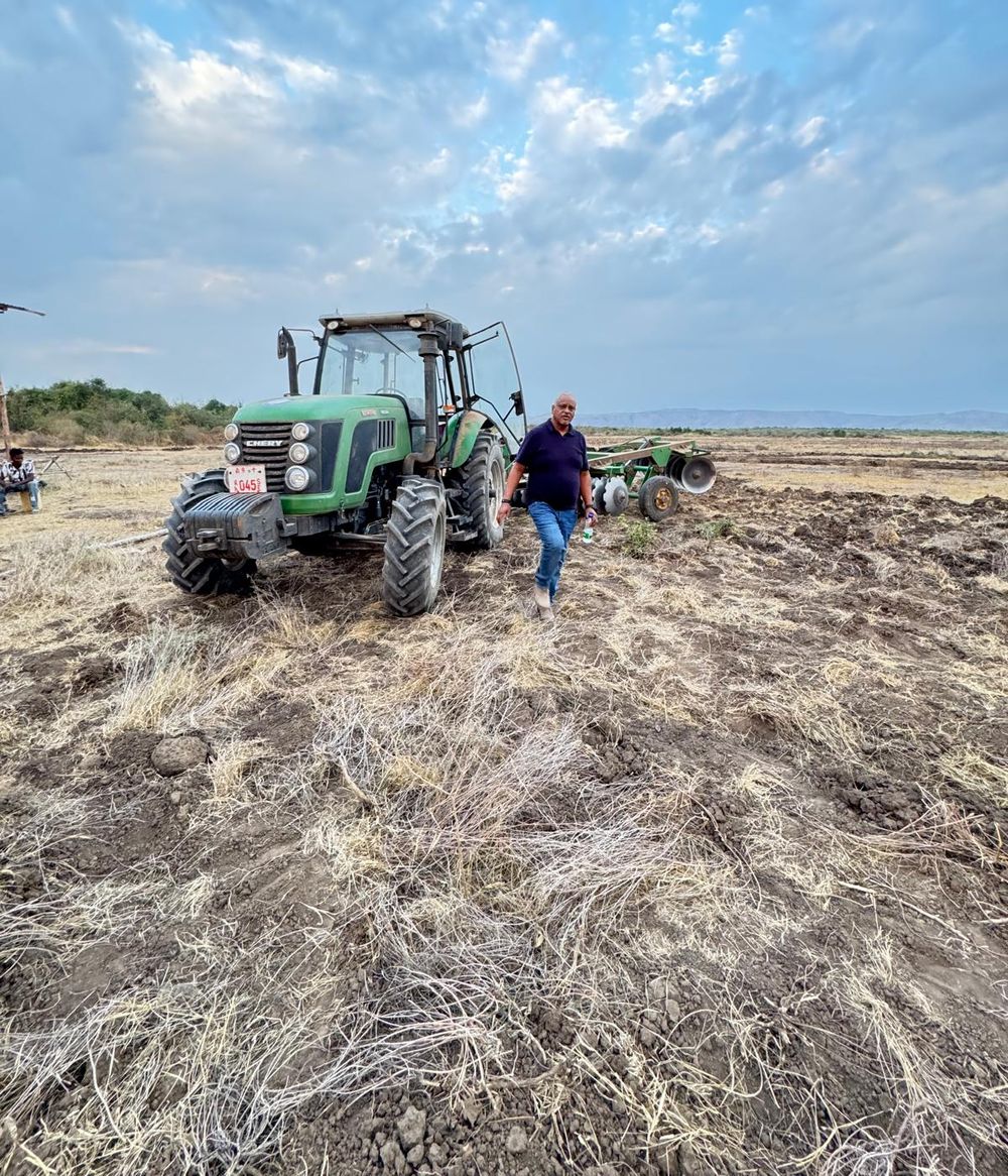 Tractor with disc harrow preparing a field